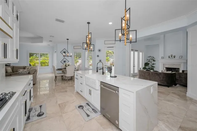 a spacious bathroom with double vanity sink a two mirror a window and a bathtub
