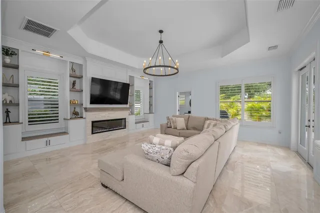 a living room with furniture and a chandelier