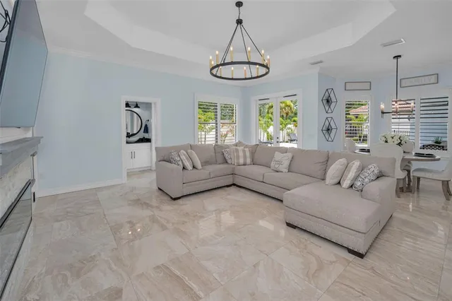 a view of a hallway with wooden floor and a living room