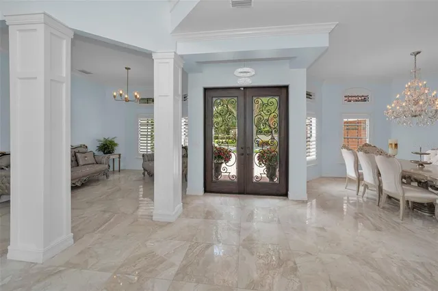 a living room with furniture a couch and a chandelier