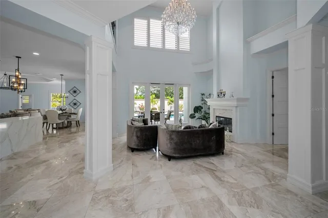 a living room with furniture a fireplace and a potted plant