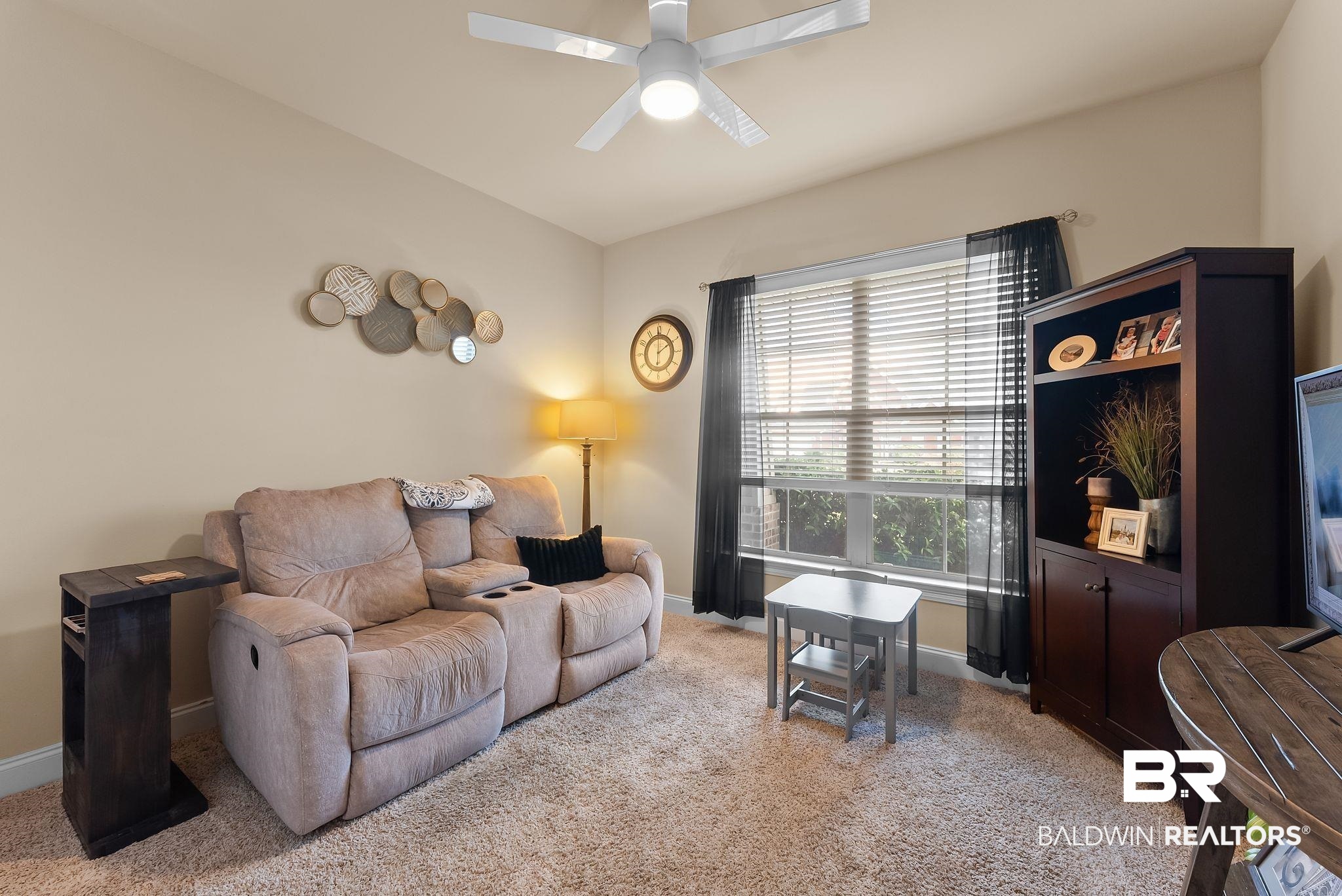 7015 Rocky Rd Loop Gulf Shores, AL 36542 - Photo 13 of 41 Living area featuring ceiling fan, plenty of natural light, and light colored carpet