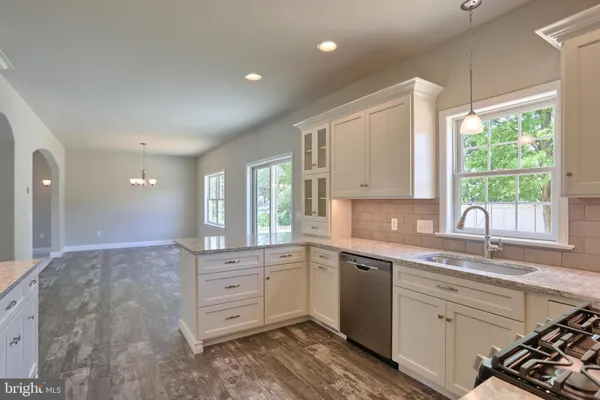 a kitchen with a sink window and cabinets