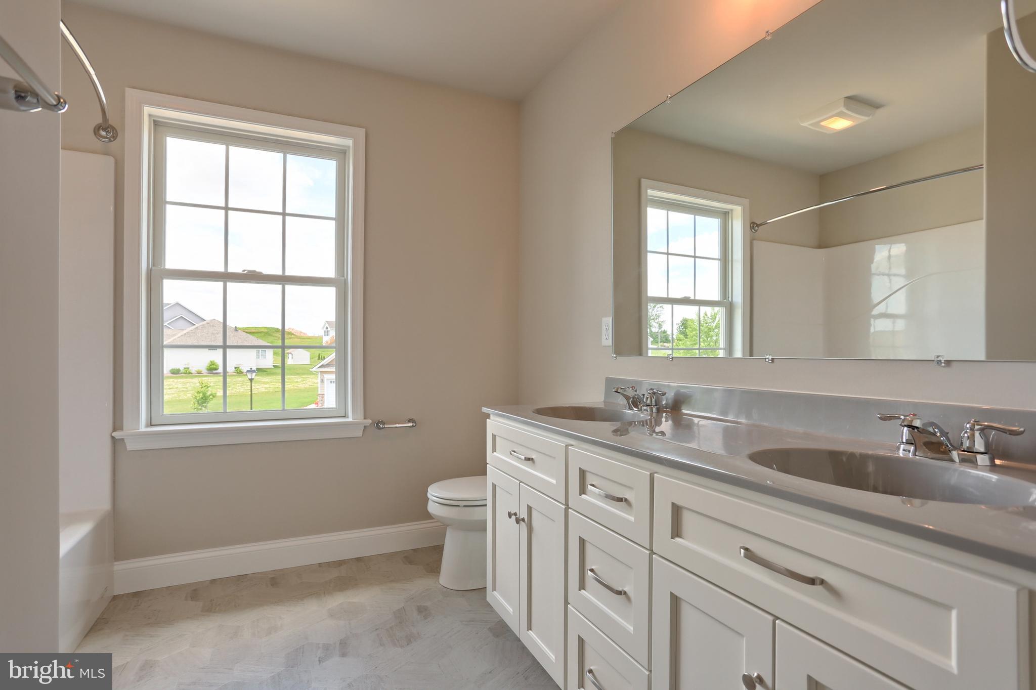 1 Rolling Meadow Road Lebanon, PA 17046 - Photo 21 of 21 a bathroom with double vanity sink a mirror a window and a shower