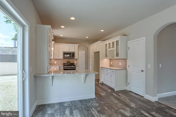 a kitchen with a refrigerator and a sink