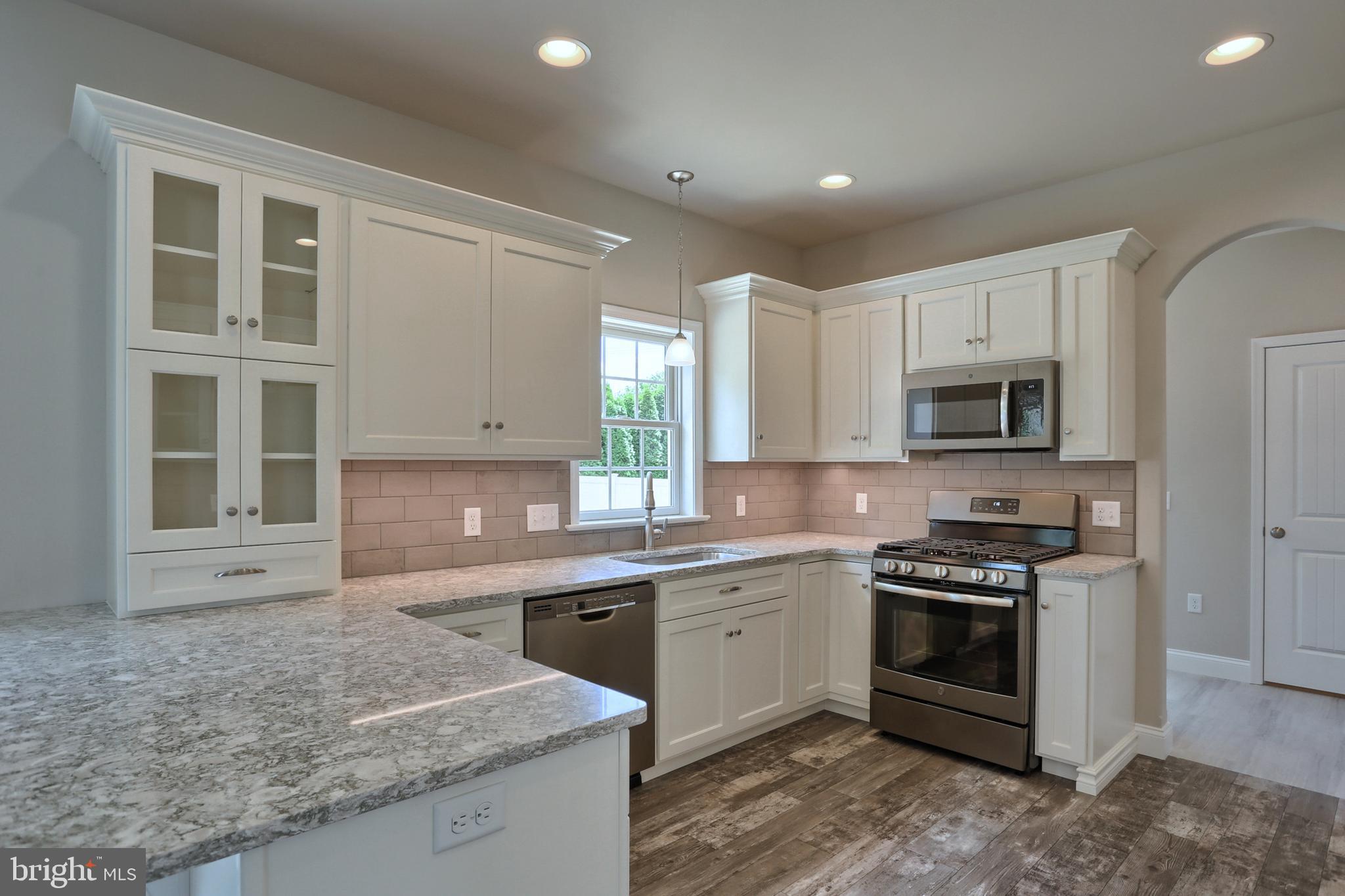 1 Rolling Meadow Road Lebanon, PA 17046 - Photo 10 of 21 a kitchen with stainless steel appliances granite countertop a stove a sink and a microwave