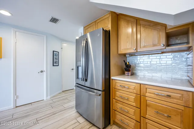 a view of a hallway with wooden floor and stairs