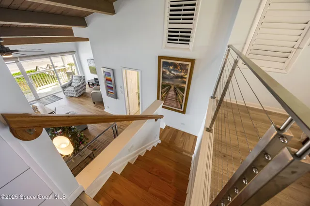 a bedroom with a bed and a ceiling fan