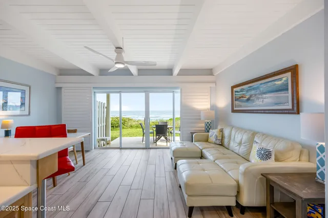 a living room with furniture and kitchen view