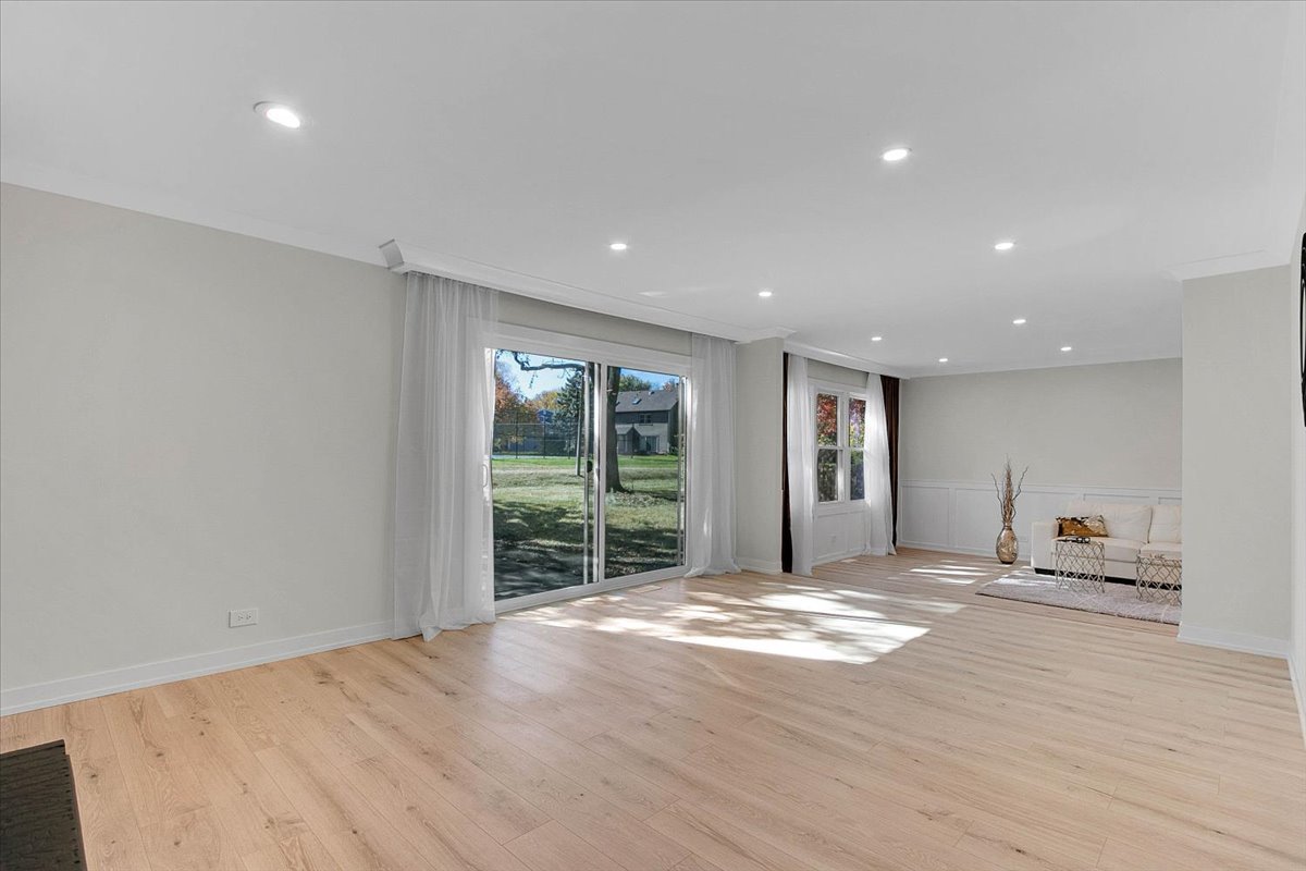 6705 Breckenridge Road Lisle, IL 60532 - Photo 19 of 41 a view of an empty room with window and wooden floor