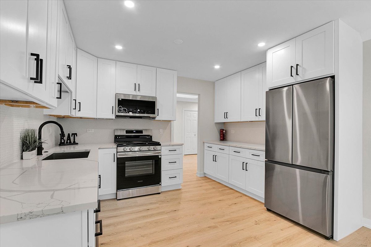 6705 Breckenridge Road Lisle, IL 60532 - Photo 29 of 41 a kitchen with white cabinets and stainless steel appliances