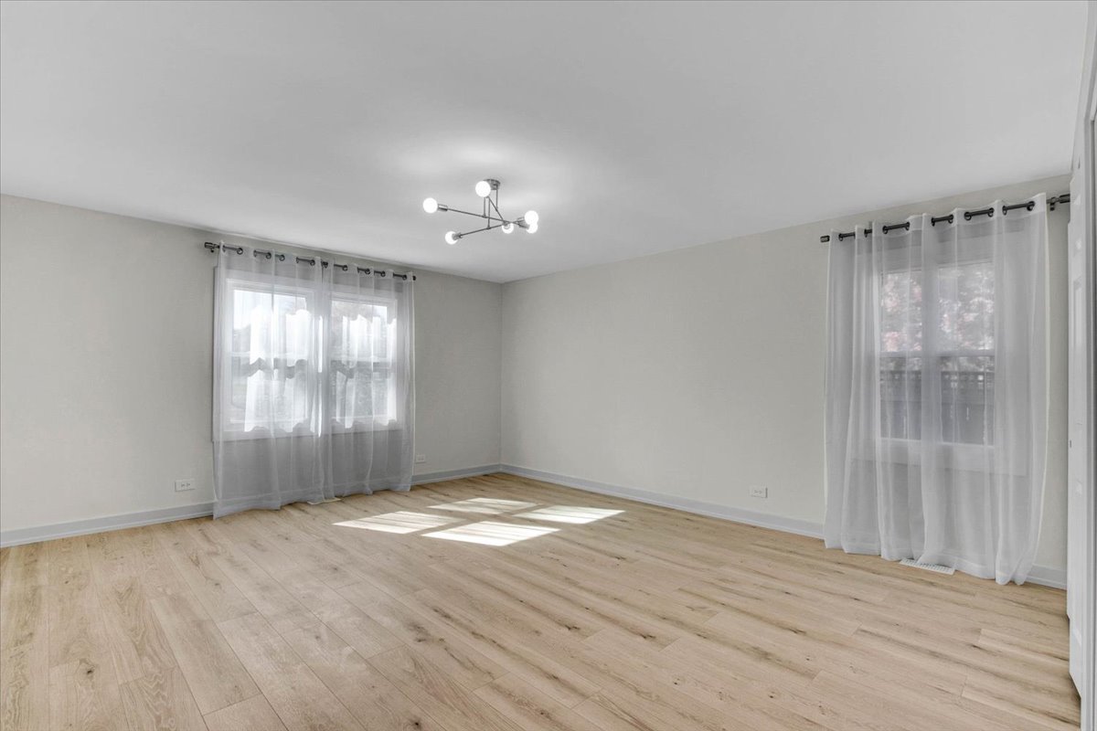 6705 Breckenridge Road Lisle, IL 60532 - Photo 3 of 41 a view of an empty room with wooden floor and a window