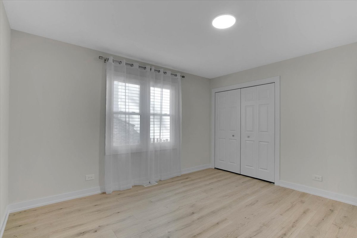6705 Breckenridge Road Lisle, IL 60532 - Photo 8 of 41 a view of an empty room with wooden floor and a window