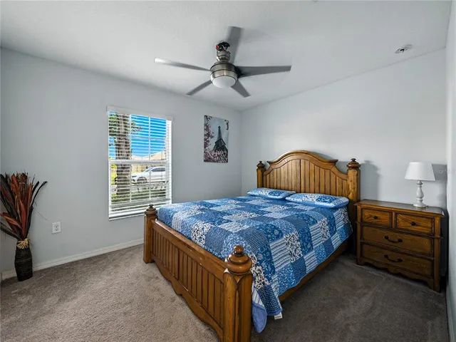 a bedroom with a bed table and window