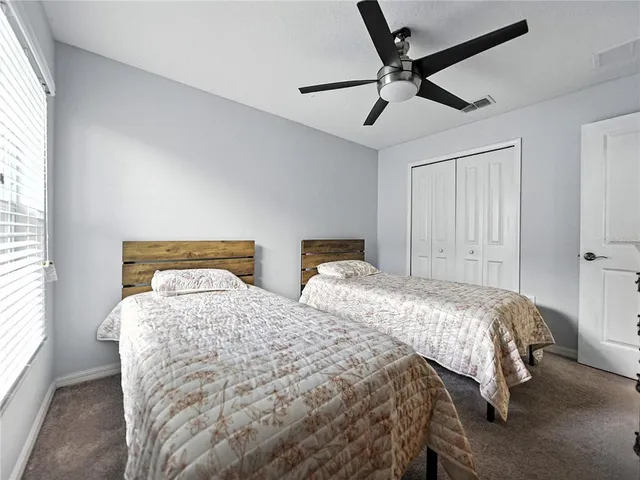 a bedroom with two beds and ceiling windows