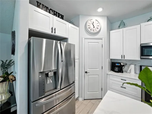 a kitchen with stainless steel appliances a refrigerator and a stove top oven