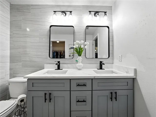 a bathroom with 2 sink and a toilet