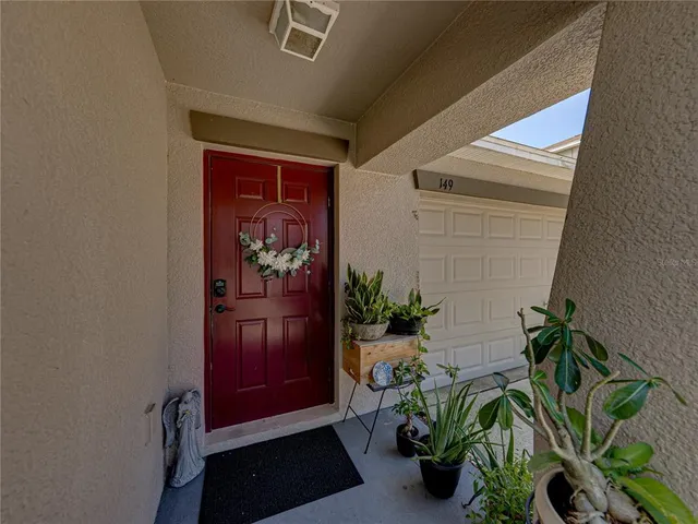 a vase of flowers sitting on a table in front of a door