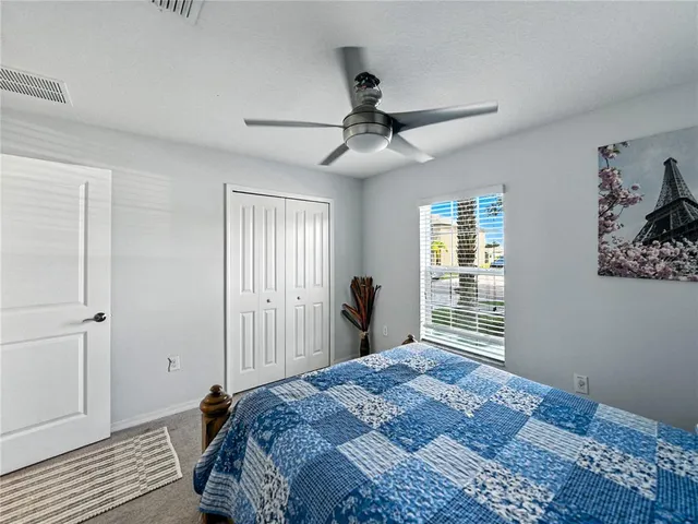 a bedroom with a large bed and a window