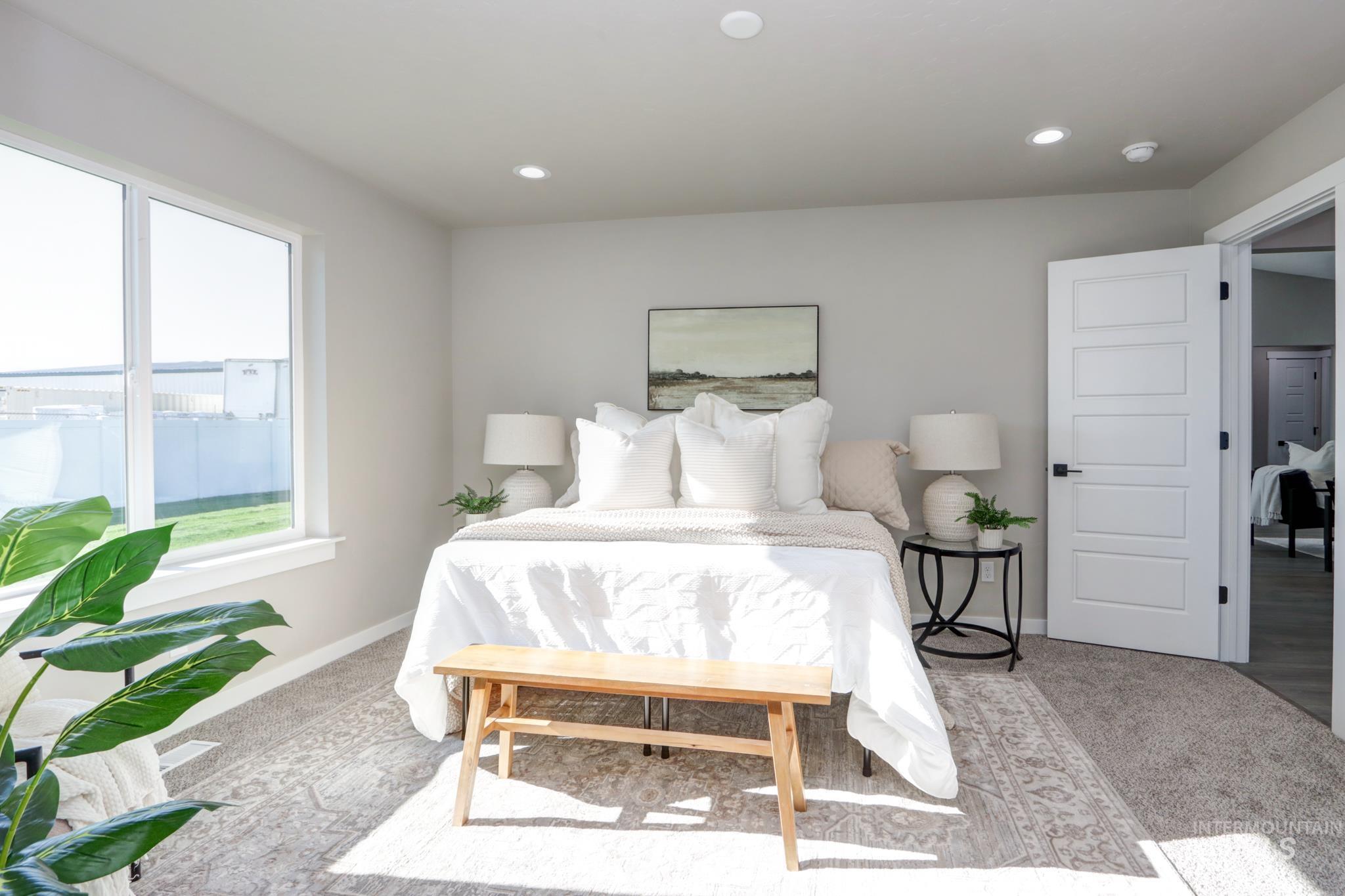 848 North 5th Street Nyssa, OR 97913 - Photo 15 of 49 Light-filled bedroom featuring a large window, recessed lighting, and soft gray carpeting