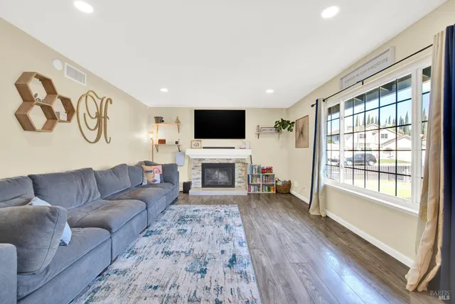 a kitchen with a sink dishwasher a stove and a refrigerator with wooden floor