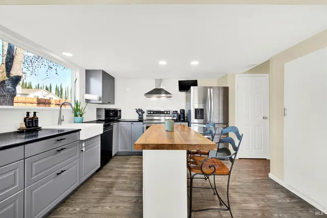 a view of a dining room with furniture wooden floor and chandelier