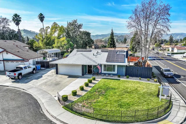 a front view of a house with a garden and plants