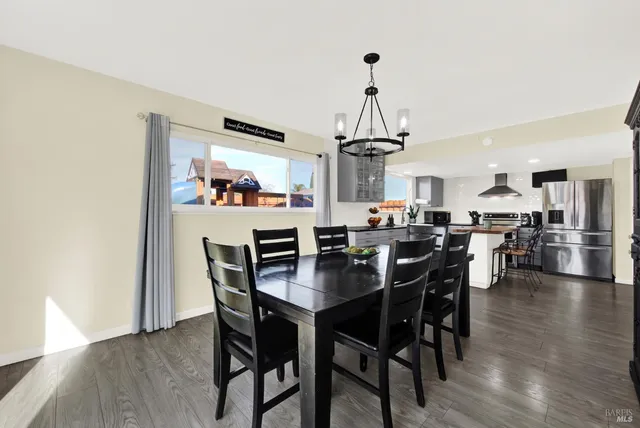an aerial view of a house with swimming pool and outdoor seating