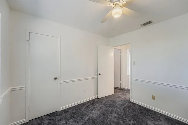 a view of a livingroom with a ceiling fan and window