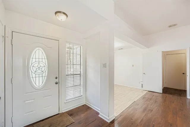 an entryway with wooden floor