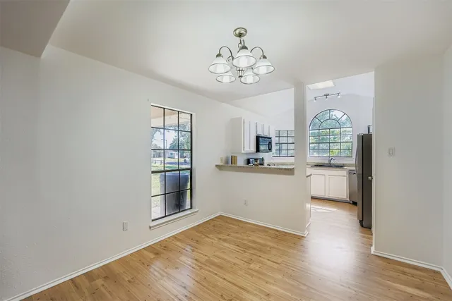 a kitchen with a refrigerator and a stove top oven