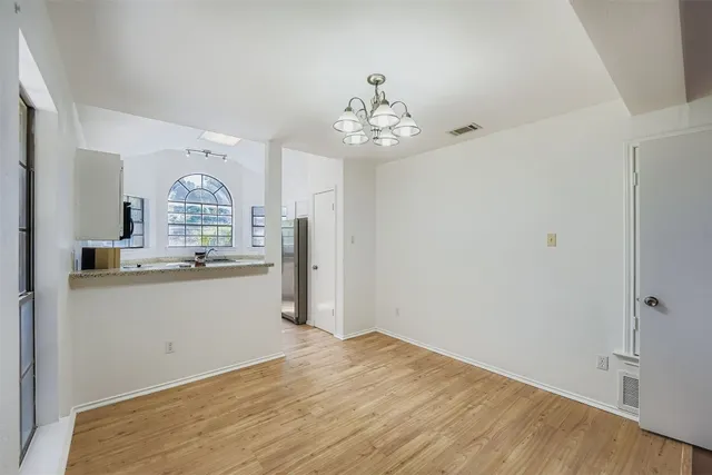 a view of a kitchen with granite countertop cabinets and a wooden floor