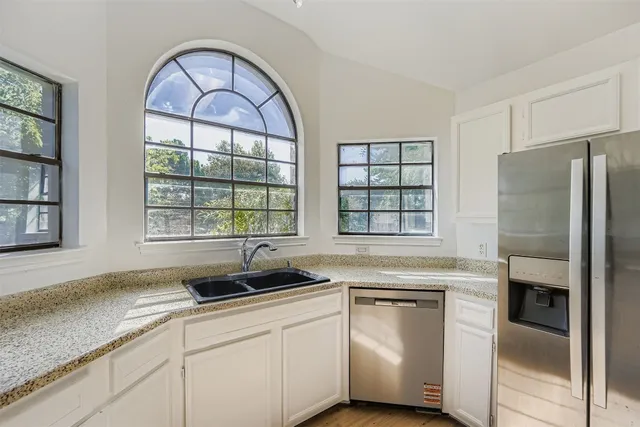 a kitchen with a stove a sink and a window
