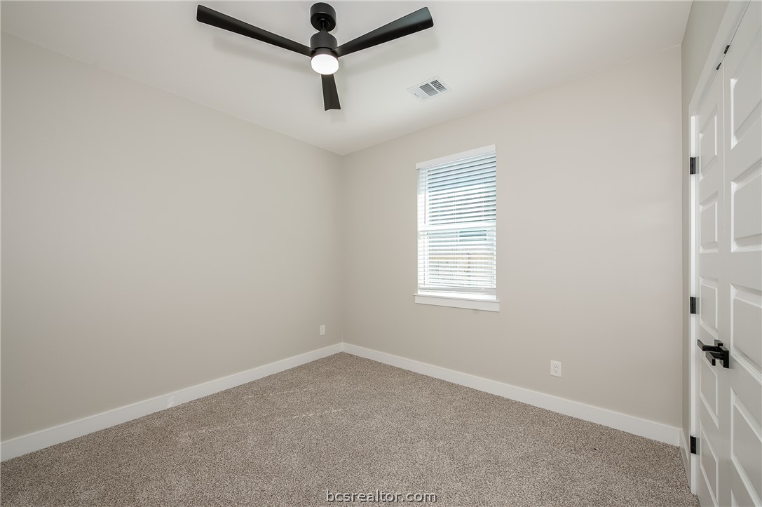 2908 GOLDBERG Drive Bryan, TX 77808 - Photo 10 of 44 Bedroom features: window treatments, base molding, ceiling fan with a light kit plus remote control and carpeting.