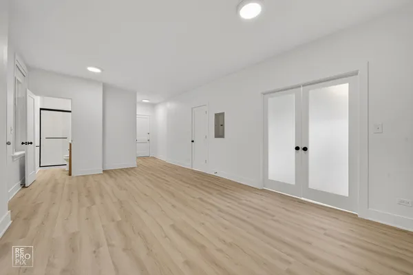 a view of empty room with wooden floor