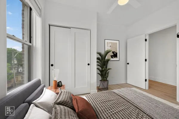 a bedroom with a bed and a couch