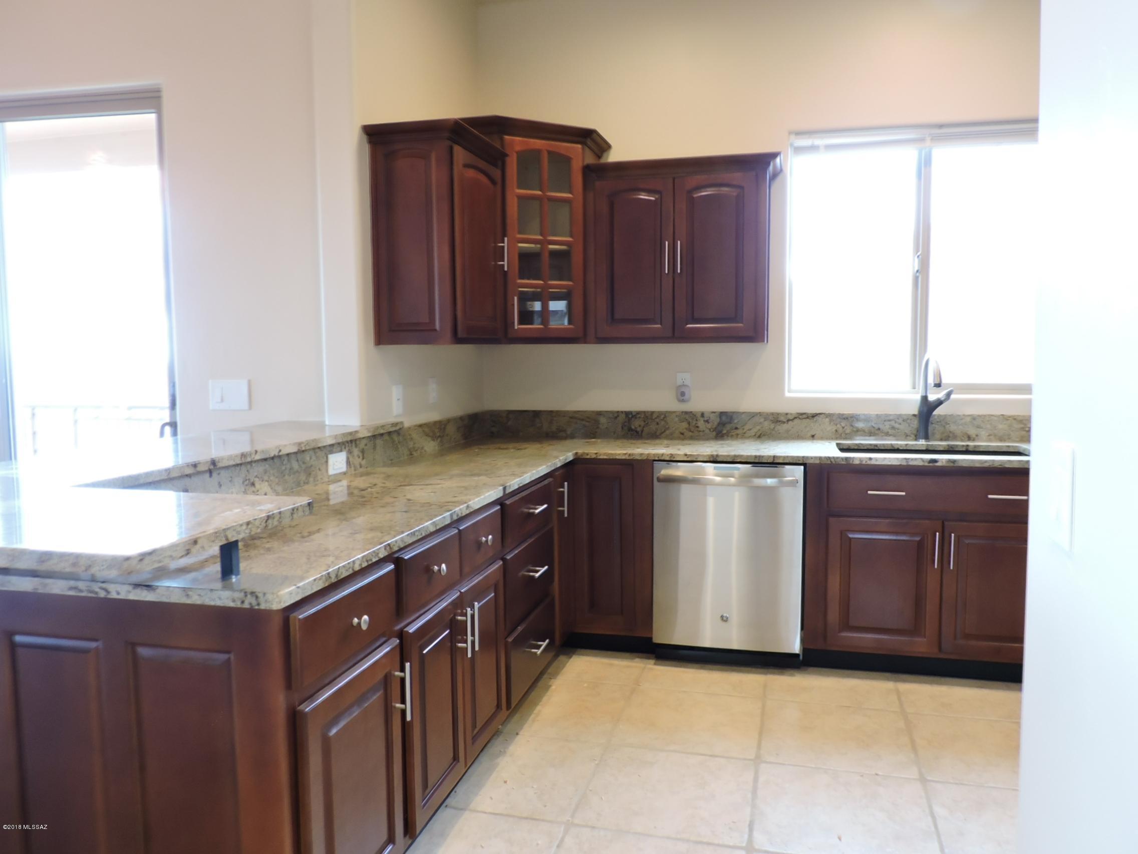 1716 Ave Calamar Rio Rico, AZ 85648 - Photo 10 of 36 a kitchen with stainless steel appliances granite countertop a sink and a stove