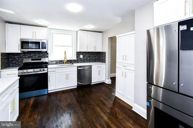 a kitchen with stainless steel appliances a refrigerator stove and sink
