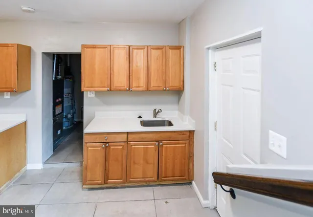 a view of kitchen and utility room with wooden floor