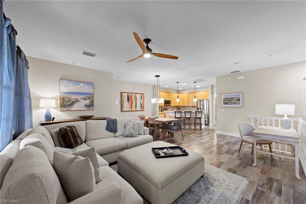 9076 Rialto Street, Unit 6204 Naples, FL 34113 - Photo 5 of 50 Spacious OPEN CONCEPT living area featuring TILE flooring, a contemporary ceiling fan, recessed lighting, and neutral wall tones. NEW TILE FLOOR (2018)