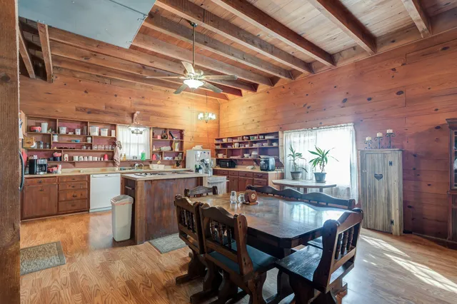a kitchen with cabinets and wooden floor