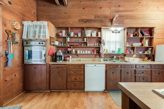 a view of a kitchen with a table and chairs