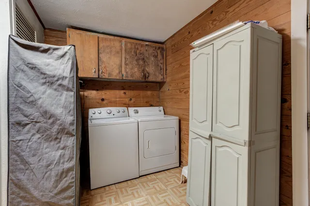 a view of walk in closet with clothes