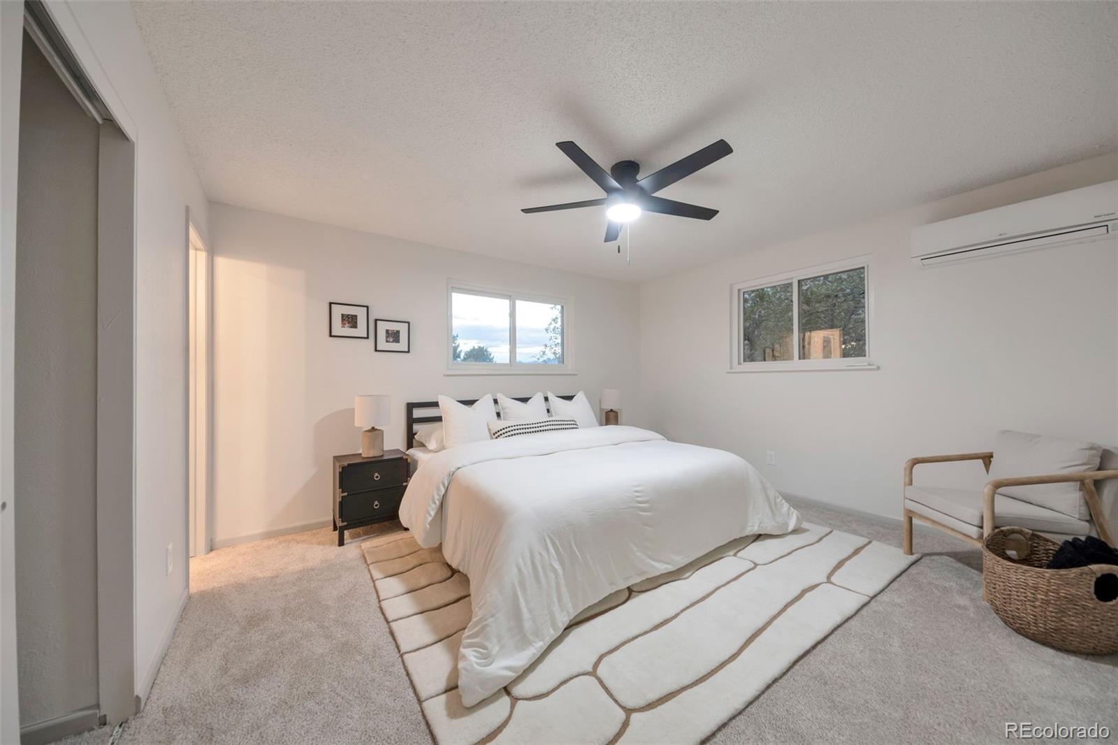 7891 Durham Way Boulder, CO 80301 - Photo 11 of 18 a bedroom with a large bed and a chandelier