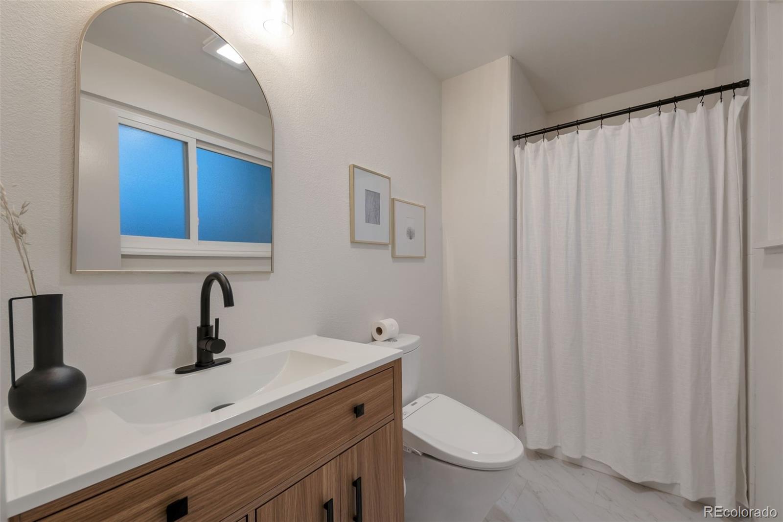 7891 Durham Way Boulder, CO 80301 - Photo 12 of 18 a bathroom with a sink a toilet and mirror