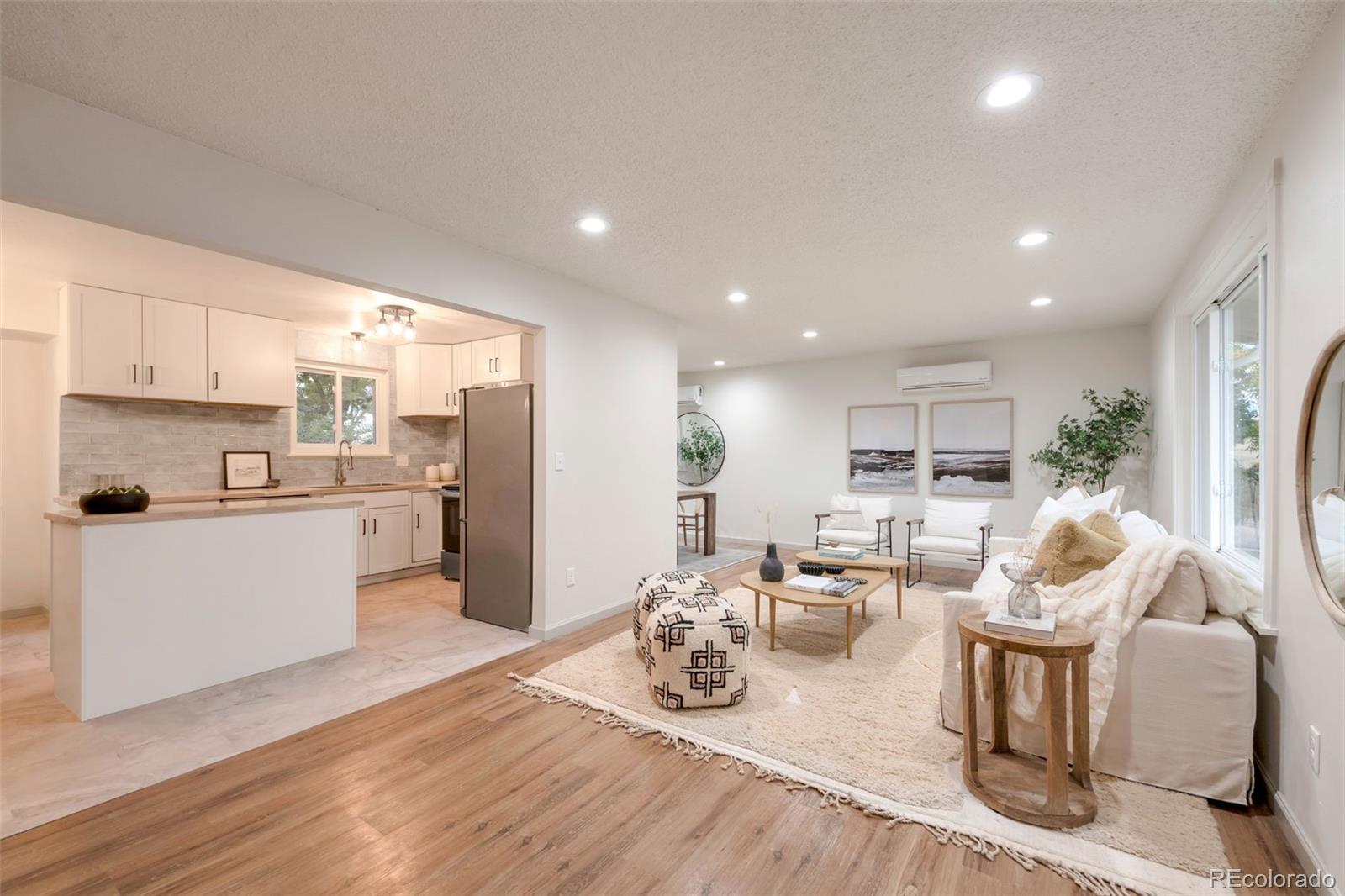 7891 Durham Way Boulder, CO 80301 - Photo 3 of 18 a kitchen with stainless steel appliances kitchen island granite countertop a refrigerator a stove and white cabinets with wooden floor