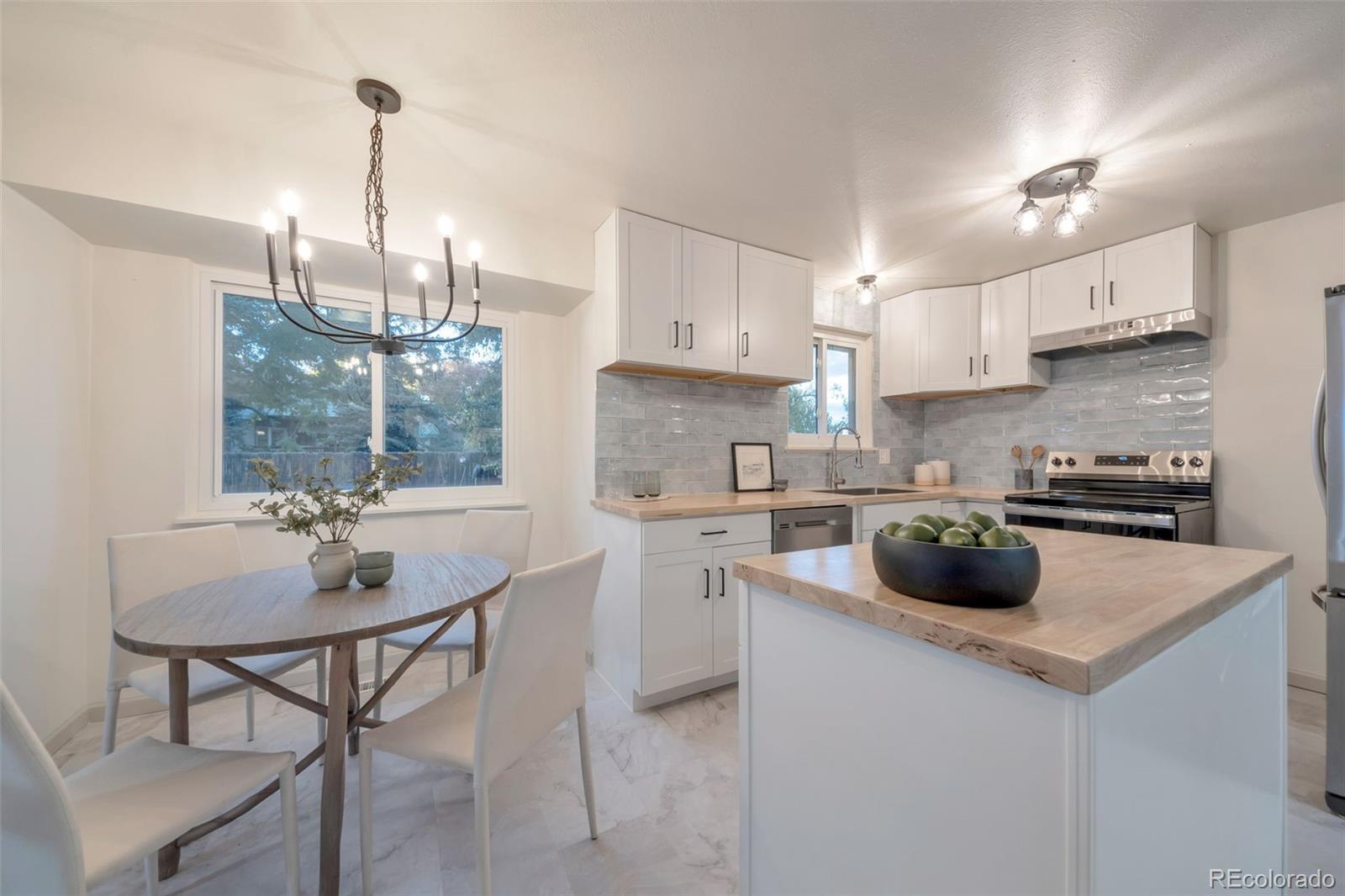 7891 Durham Way Boulder, CO 80301 - Photo 6 of 18 a kitchen with a stove a sink and a refrigerator
