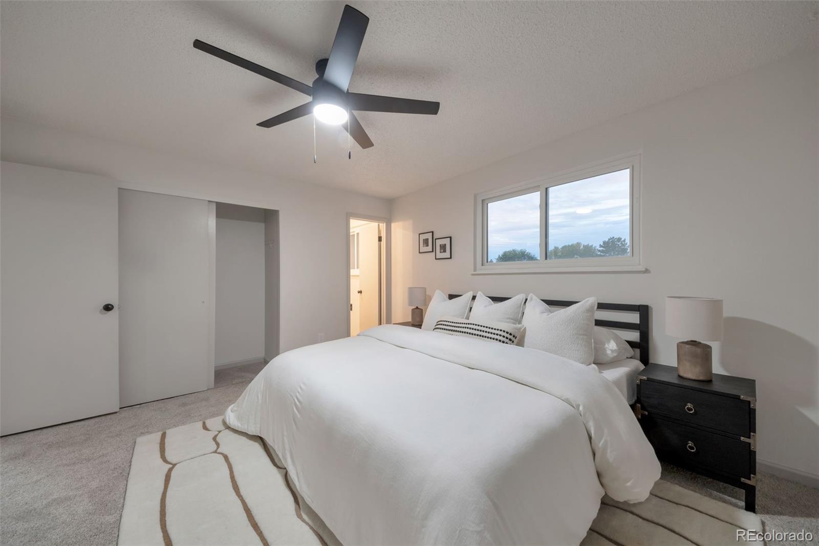 7891 Durham Way Boulder, CO 80301 - Photo 10 of 18 a bedroom with a bed and a ceiling fan