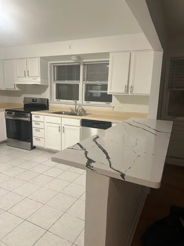 a kitchen with a stove a sink and a refrigerator