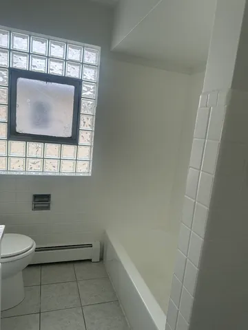 a bathroom with a toilet and a bathtub